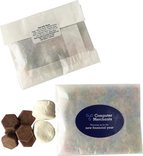 A kraft paper bag containing chocolate buttons and marshmallows, featuring a logo and a label on the packaging.