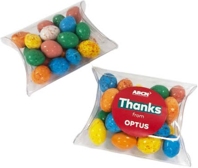 Pillow pack containing colourful chocolate eggs in various shades, including blue, green, orange, and yellow.