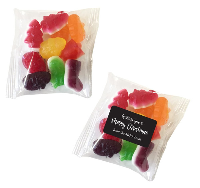 A clear bag filled with assorted mixed lollies in bright colours, including red, green, and orange.