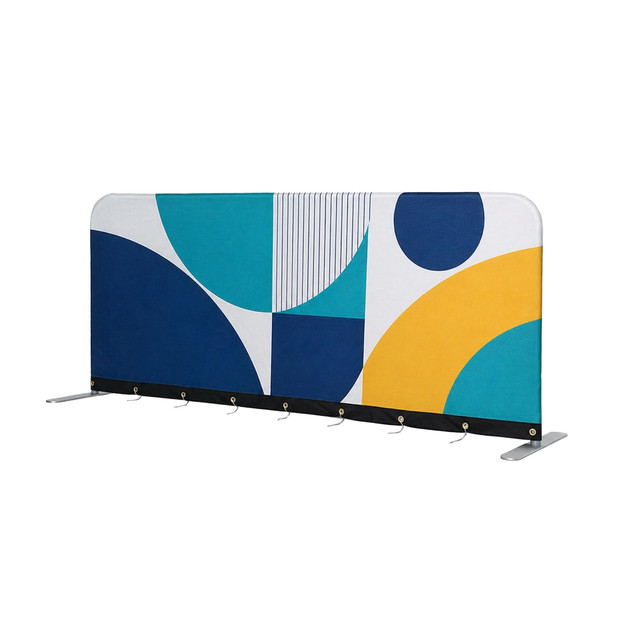 A barrier featuring a geometric design in teal, navy, yellow, and white, with a logo at the top.