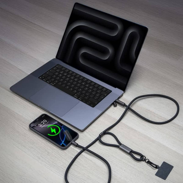 A black braided lanyard phone strap connected to a laptop and a smartphone, showcasing charging capability.