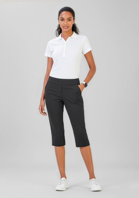 A pair of women's black 3/4 length stretch pants displayed on a model wearing a white polo shirt.