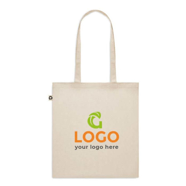 A beige recycled cotton tote bag with a logo on the front and two handles.