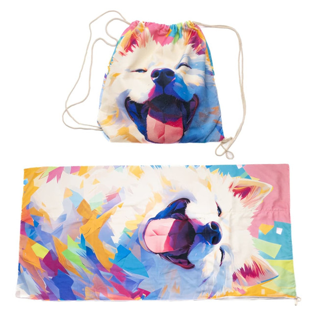 A foldable drawstring towel featuring a vibrant, multicoloured design of a smiling dog, with a matching drawstring bag.