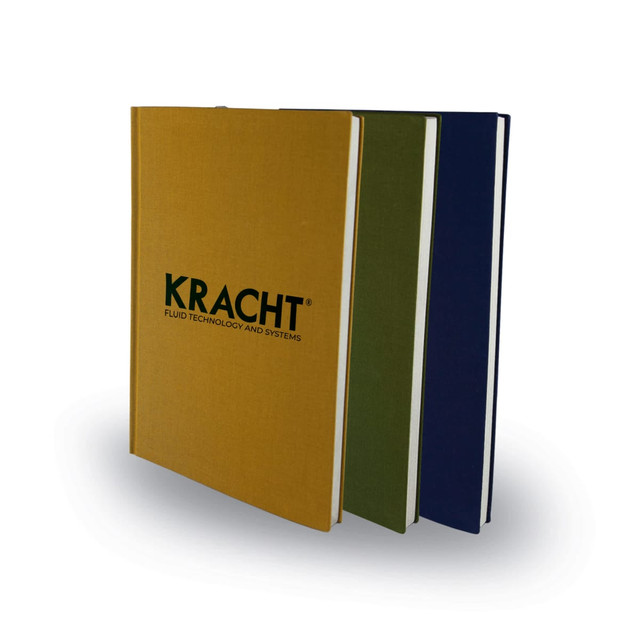 A set of three A5 notebooks featuring yellow, green, and navy covers, each with a logo on the front.