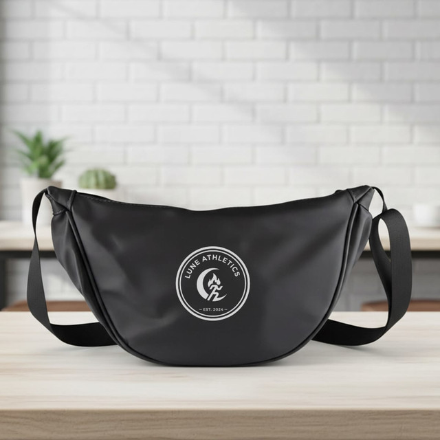 A black promotional bag with a round logo, featuring a single strap for wearing crossbody.