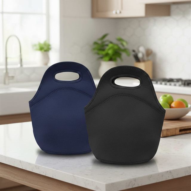 A navy blue and a black neoprene lunch bag are displayed on a kitchen counter, featuring built-in handles.