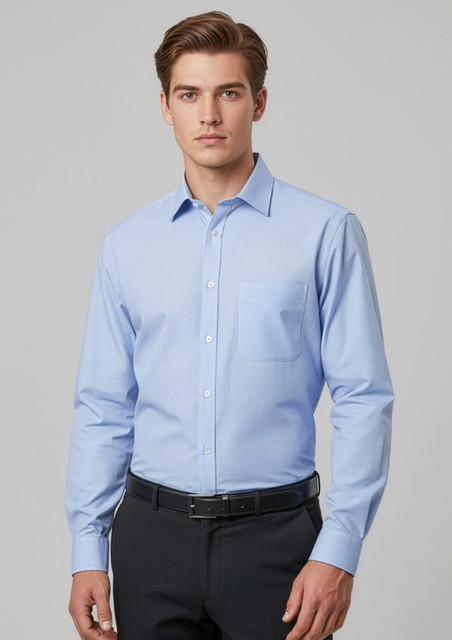 A light blue long sleeve button-up shirt with a pocket and a logo, worn by a model.