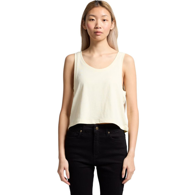 A cropped singlet in pale yellow worn with black pants, featuring a simple design and a small logo.