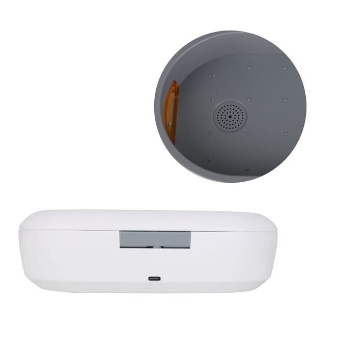 A white UV sterilisation box with a wireless charger. It features a grey interior and a small speaker-like perforation.