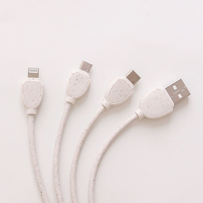 A round-shaped charging cable in white, made from wheat straw, featuring multiple connectors for various devices.