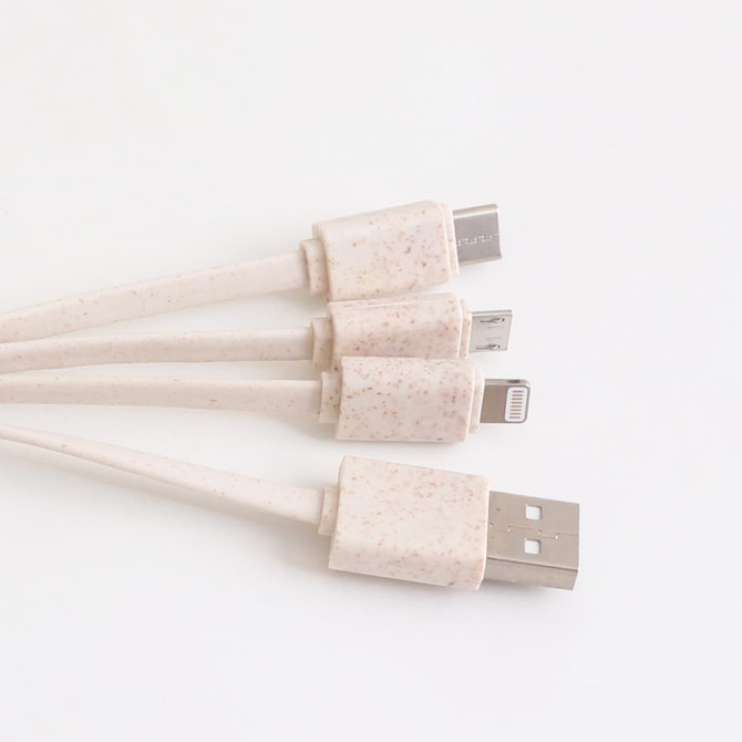 A square-shaped charging cable in a light cream colour with multiple connectors, including USB and Lightning.