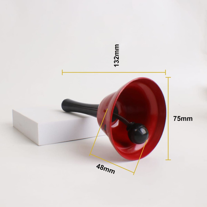 A 75mm red hand bell with a black handle, positioned next to a white rectangular box.