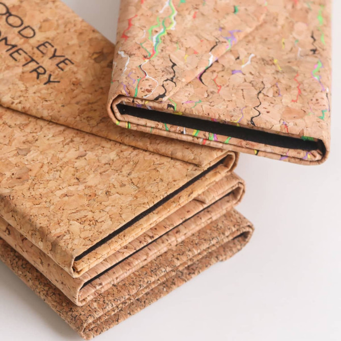 Foldable cork glasses case in natural cork with colourful accents, showcasing multiple cases stacked together.