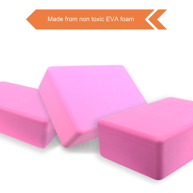 Three pink EVA yoga blocks made from non-toxic foam, arranged in varying angles against a white background.