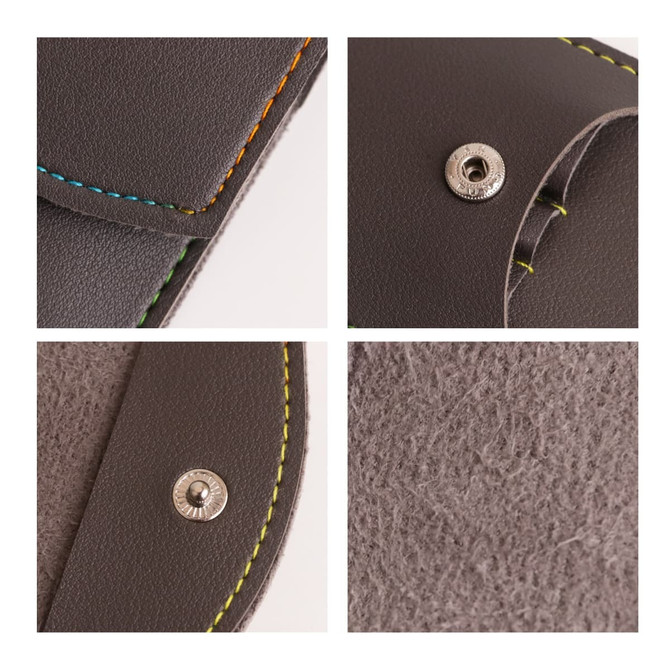 A portable manicure set in a brown case featuring colourful stitching and a metallic snap closure.
