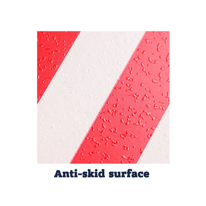A close-up of a red and white anti-skid serving tray surface with textured stripes.