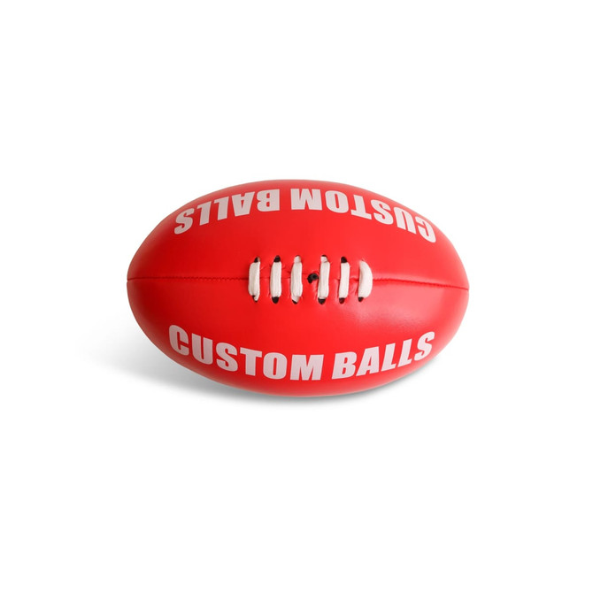 A red promotional AFL ball with white stitching and text, featuring a logo and a smooth surface.