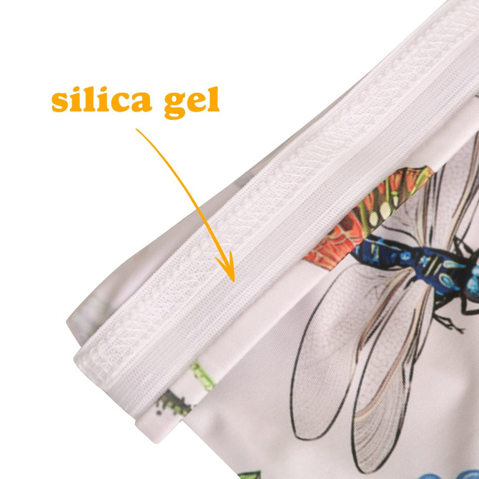 A close-up of a colourful fabric sleeve, featuring a design with insects and a silica gel tag on the edge.