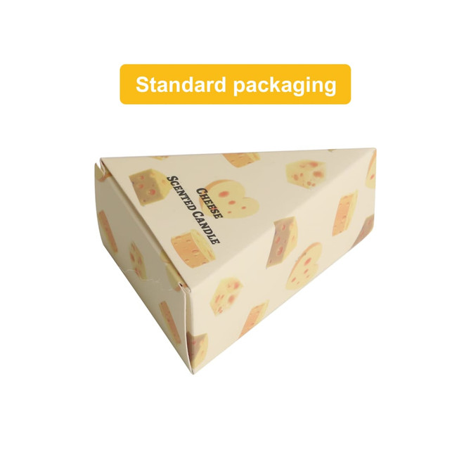 A triangular box featuring illustrations of cheese, containing scented cheese-shaped candles in yellow and cream.