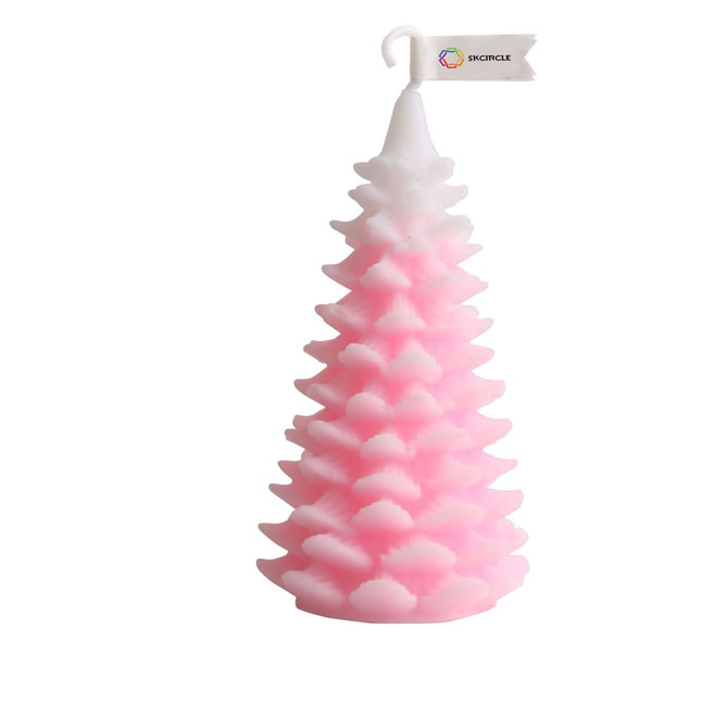 A pink cedar Christmas tree shape candle with a white top, featuring a decorative flag.