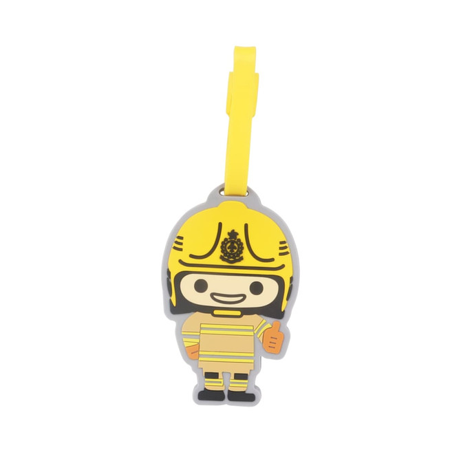 A custom-shaped PVC luggage tag in the form of a smiling cartoon firefighter, predominantly yellow with a yellow strap.