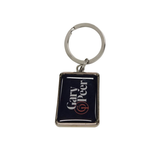 A custom-shaped metal keyring with a domed epoxy finish, featuring a rectangular design and a silver keyring.