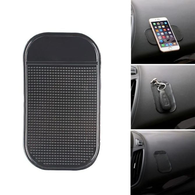 A black dashboard mat with a textured surface, designed to hold small items like phones and keys in place.