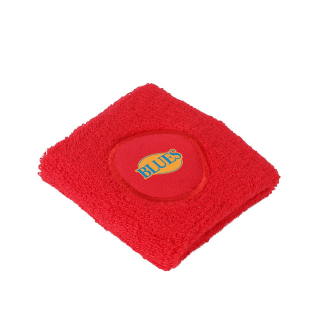 A red Terry Sport Wristband featuring a circular logo. The wristband has a soft, textured fabric.