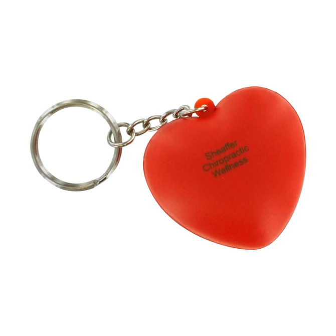 A red heart-shaped stress reliever keyring attached to a silver keychain, featuring a logo.