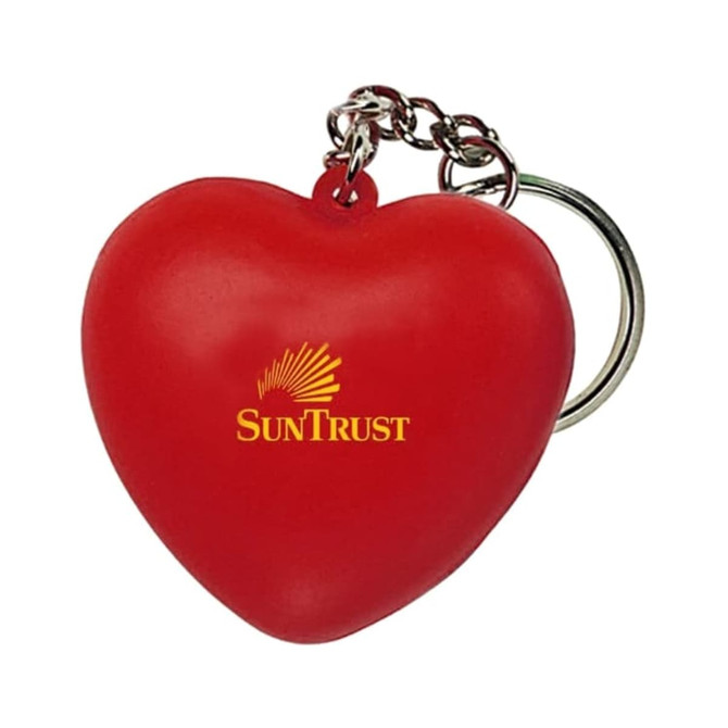 A red heart-shaped stress reliever attached to a metal keyring, featuring a logo.