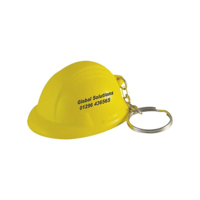 A yellow helmet stress reliever attached to a silver keyring, featuring branding on the side.