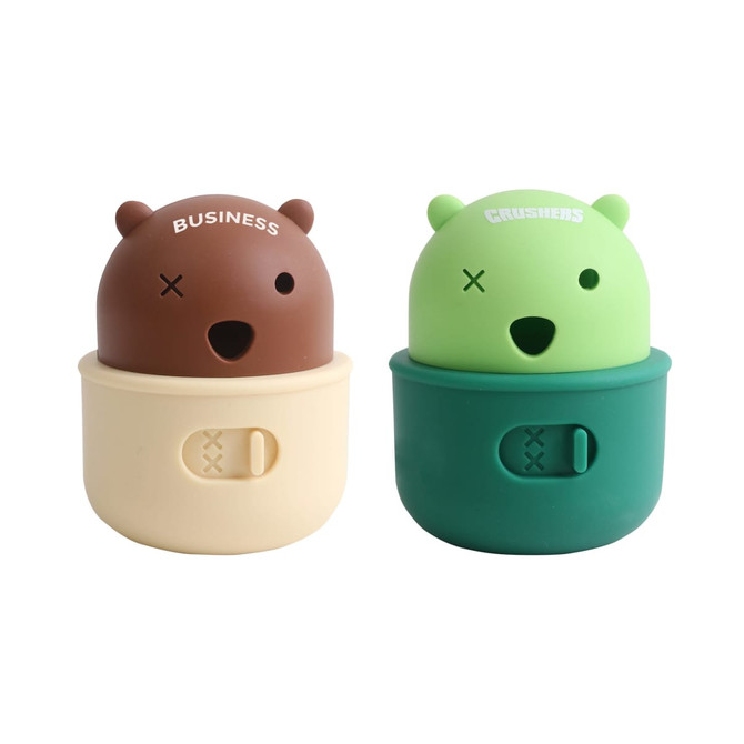A pair of bear-shaped dog treat dispenser toys in brown and green, with a creamy base and playful facial features.