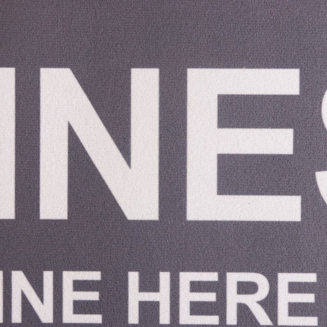 A grey floor mat featuring a logo and large text, designed for office or business environments.