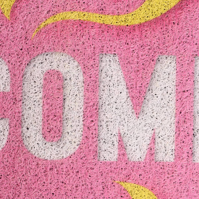 A pink floor mat featuring a textured design with a logo in white and yellow elements.