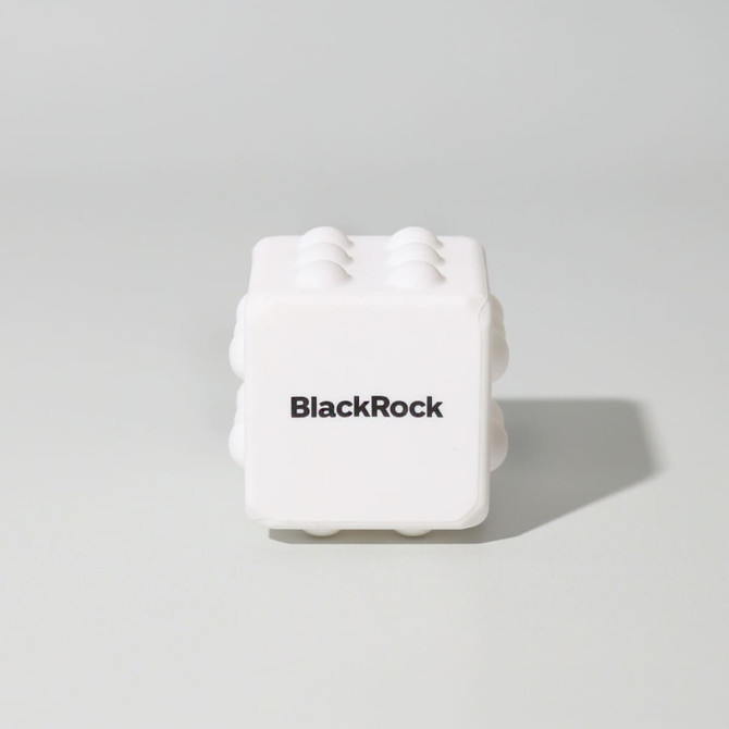 A white cube-shaped toy with raised sections and a logo on one side, designed for fun and games.