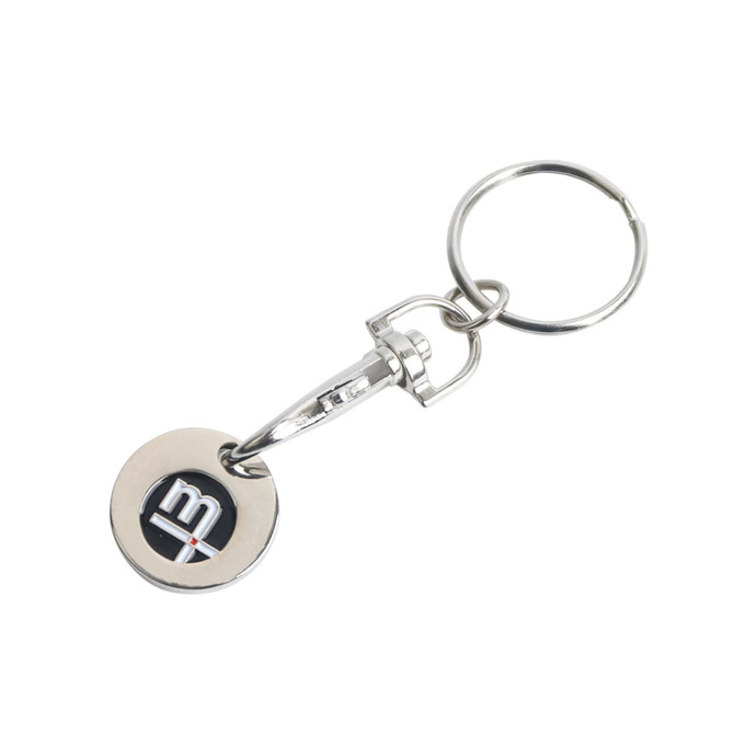 A silver keyring featuring an enamel trolley coin with a logo on it. The keyring has a circular design.