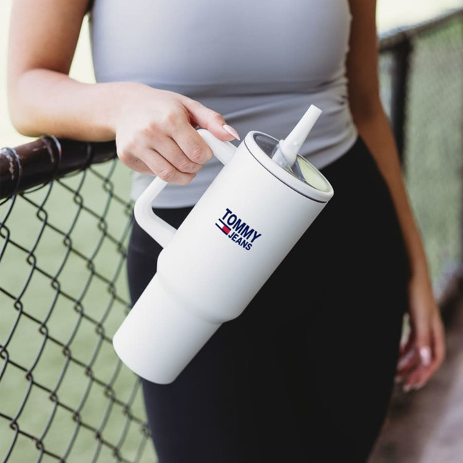 A drink bottle in white with a handle and a straw, featuring a logo on the front.