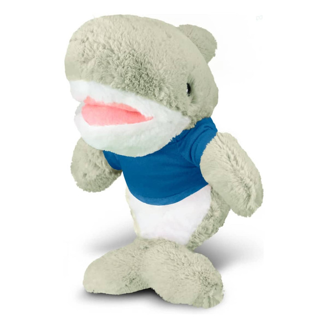 A soft, grey shark plush toy wearing a blue shirt, featuring a smiling face and plush body.