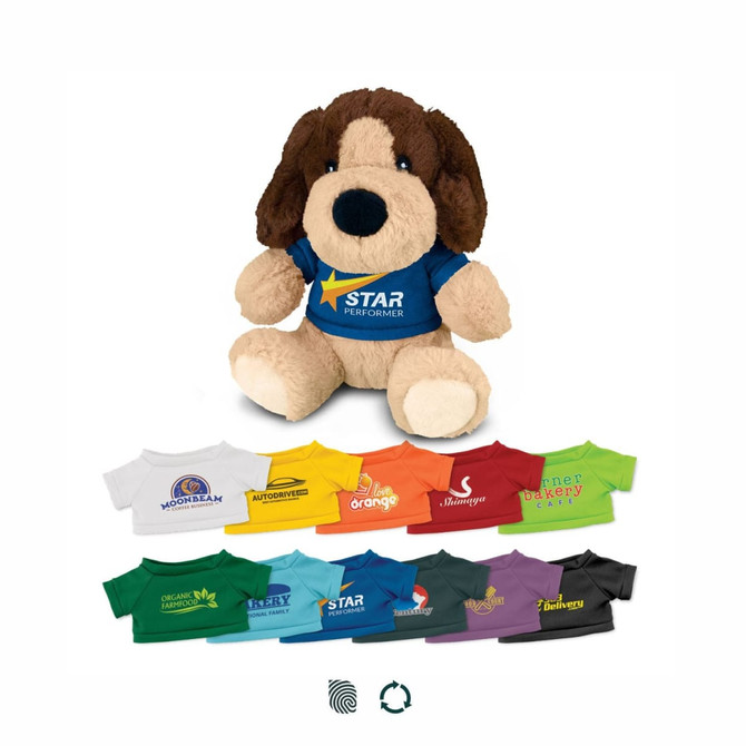 A plush dog toy in brown and cream, wearing a blue shirt with a logo, surrounded by colourful miniature shirts.