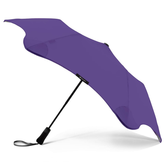 A purple BLUNT Metro Umbrella with a unique design and a black handle. It features a branding logo on the handle.