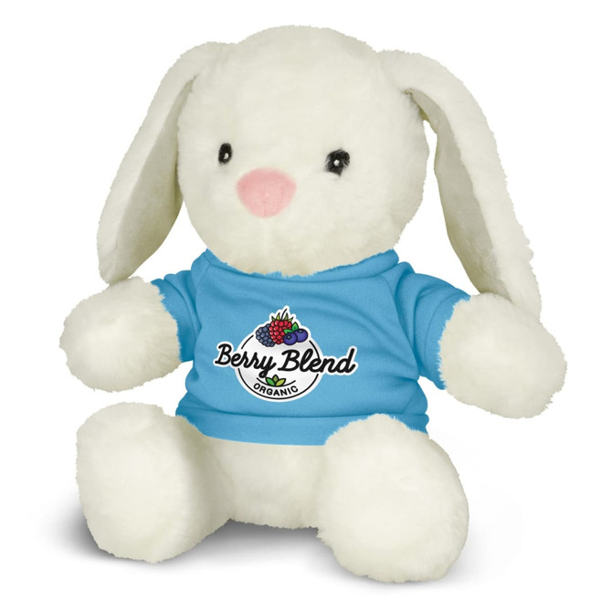 A soft, white plush toy rabbit wearing a blue shirt with a logo. It has long ears and a pink nose.