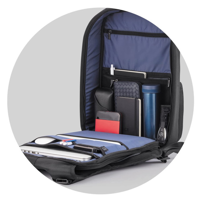 A navy blue Flex Gym Bag with multiple compartments holding a drink bottle, notebooks, and other accessories.