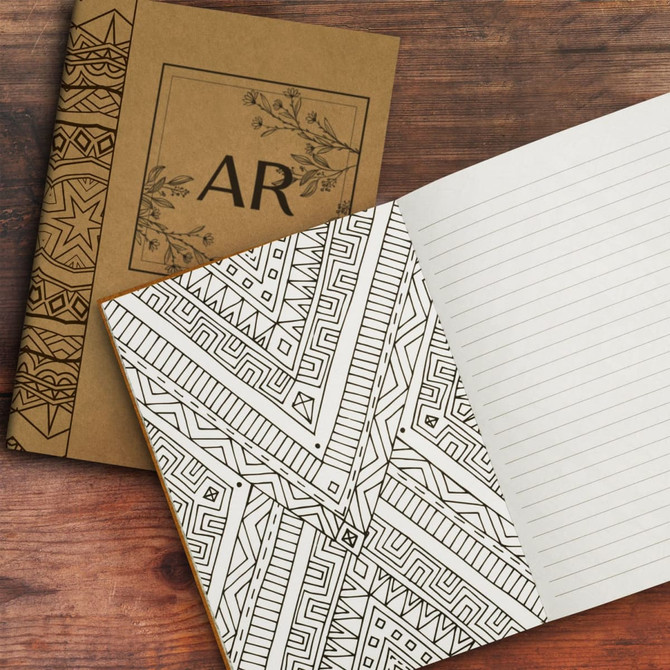 An intricately designed brown notebook featuring a geometric patterned interior with lined pages.