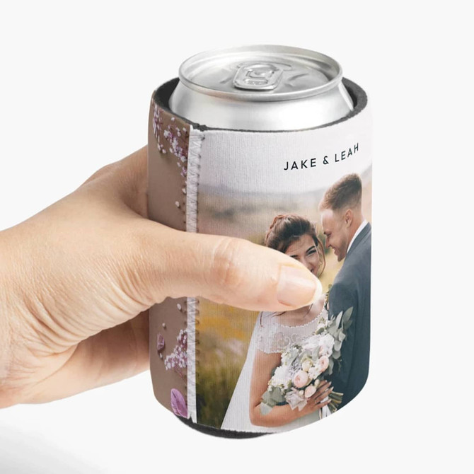 A stubby holder featuring a full-colour design with a wedding photo, held by a hand, suitable for a drink can.