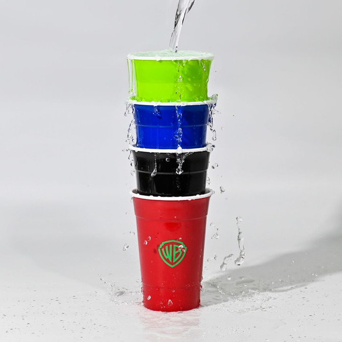 A stack of four double wall party cups in red, black, blue, and green with water pouring over them. Contains a logo.