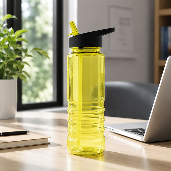 A drink bottle in bright yellow with a black lid and straw, placed on a wooden desk beside a plant.