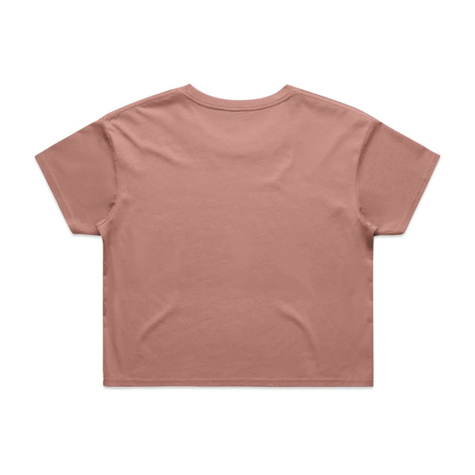 A cropped tee in a muted peach colour, featuring a simple design and a logo. The shirt has short sleeves and a relaxed fit.