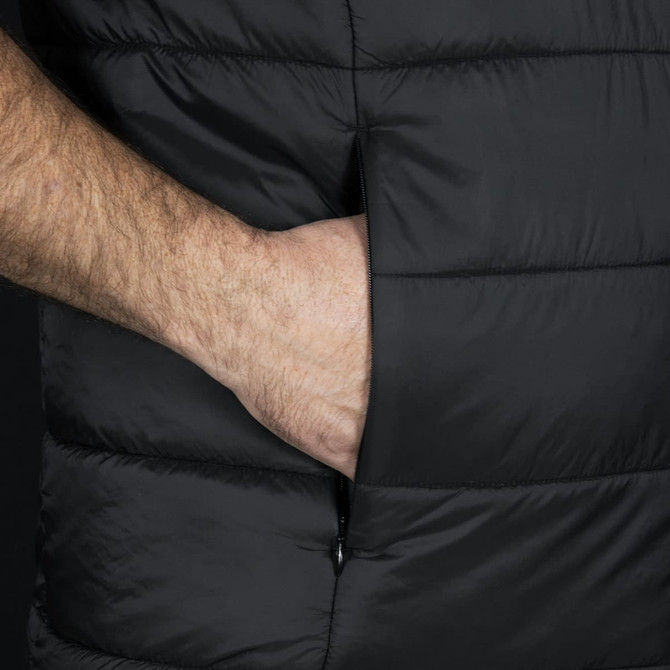 A black puffer vest featuring a side pocket, highlighting a hand placed inside the pocket.