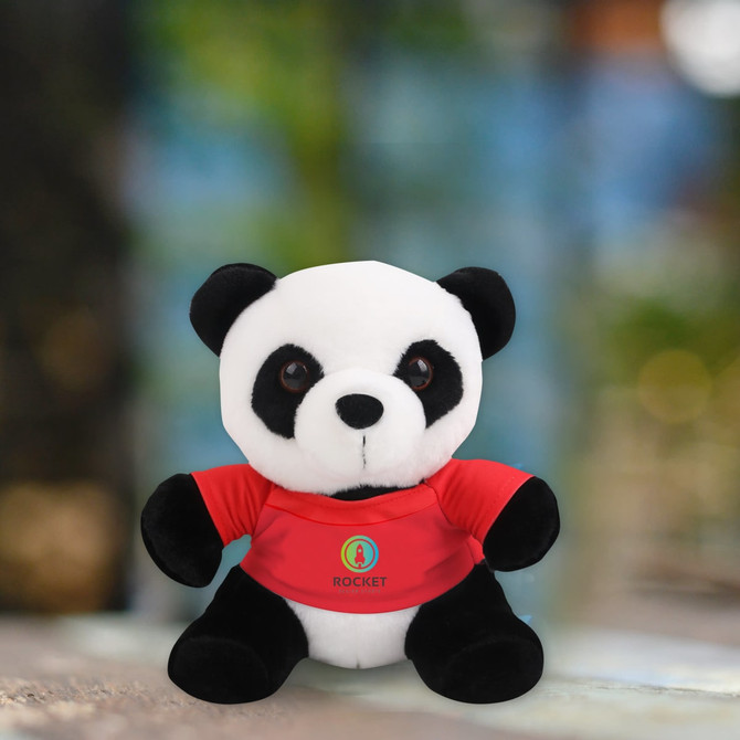 A plush toy panda wearing a red shirt with a logo, featuring black and white fur.